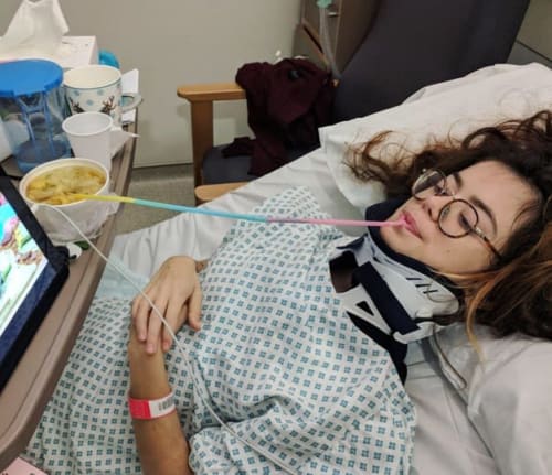 Grace lying in a hospital bed