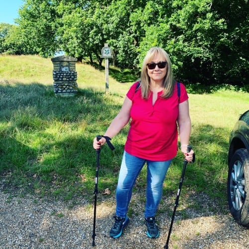 Nikki with walking poles in the countryside