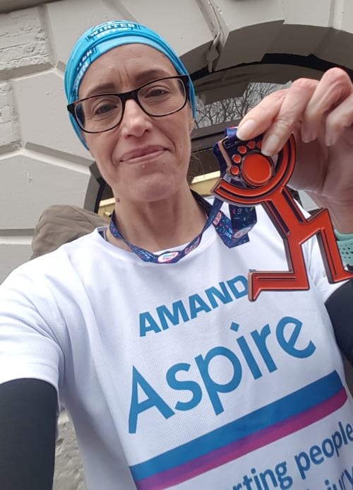 Amanda in Aspire t-shirt with medal