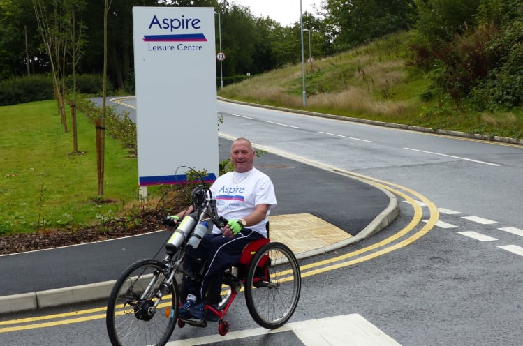 Joe by the Aspire Leisure Centre sign