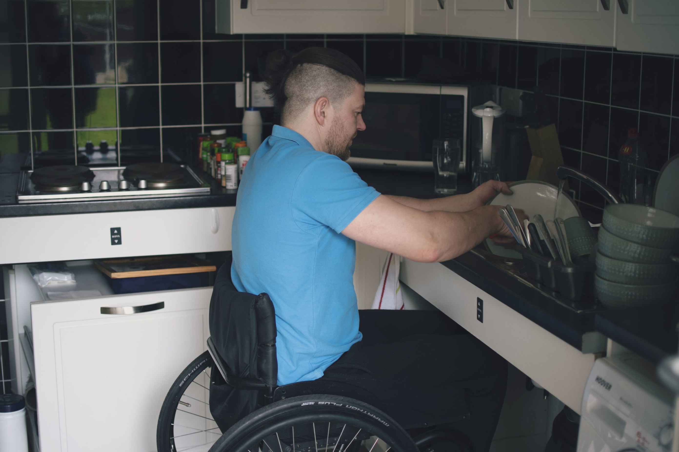 Einers in his wheelchair washing up