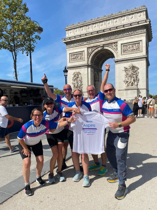 The team holding an Aspire banner at the Arc de Triomphe