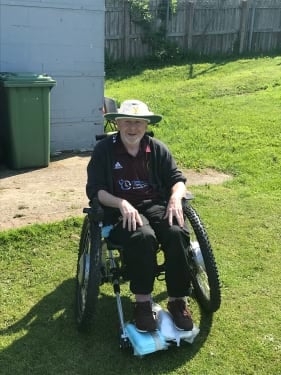 John in his wheelchair outside