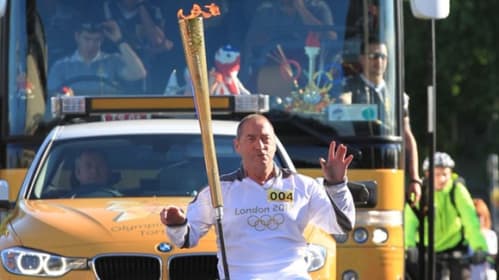 Joe holding the Olympic torch in 2012