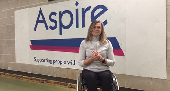Paula Craig in front of the Aspire sign
