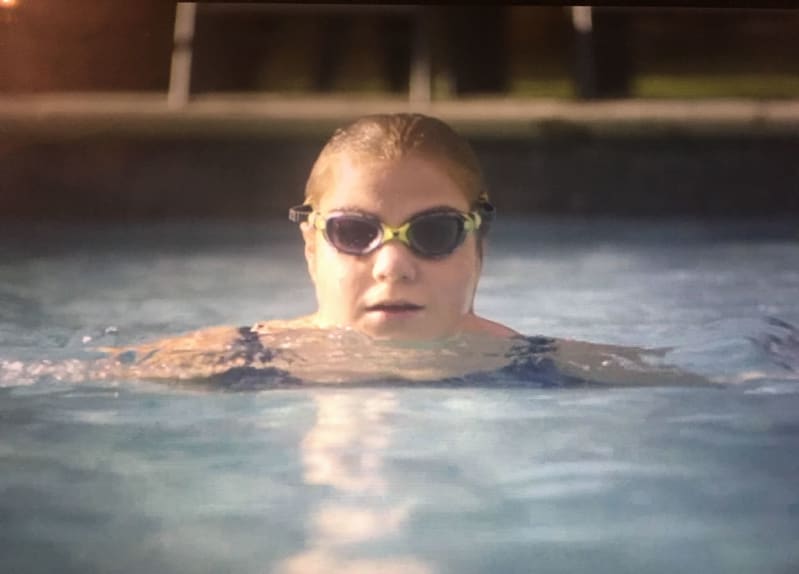 Suzie swimming in a pool