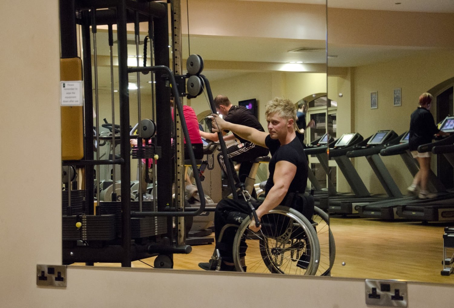 Charlie in his wheelchair, working out in the gym