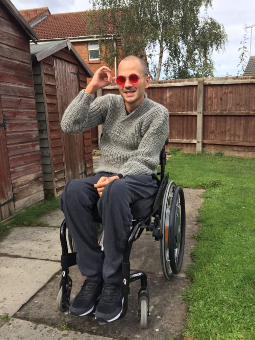 Stan in his garden in a wheelchair