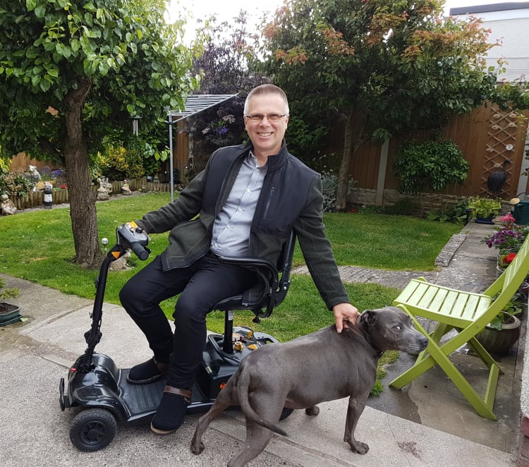 David on his scooter with his dog