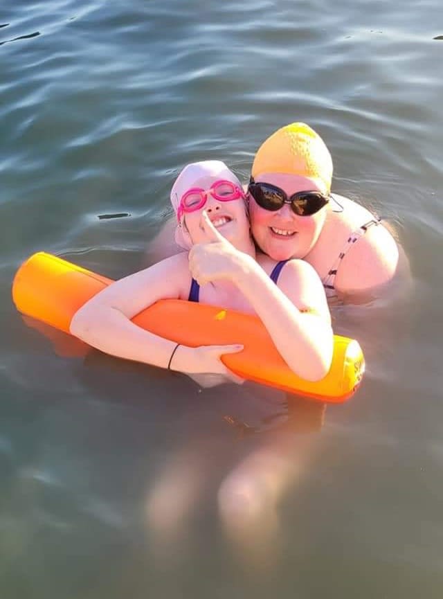 Olivia with her daughter in the water