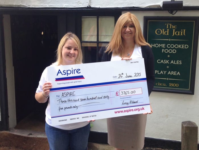 Lucy Hibberd presenting a cheque to Aspires Hannah Wyatt