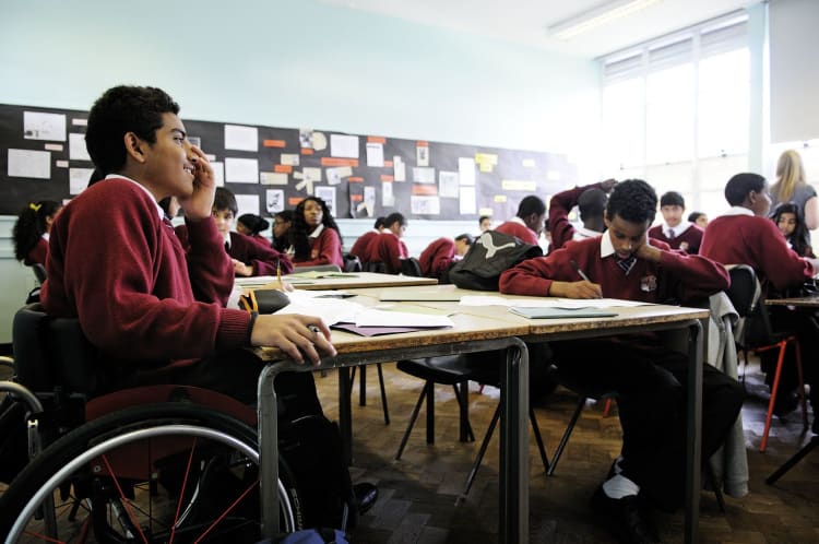 Boy in wheelchair in a classroom at school 