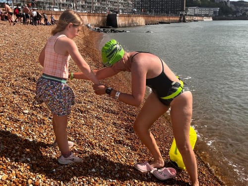 Louise being helped out the water by her daughter