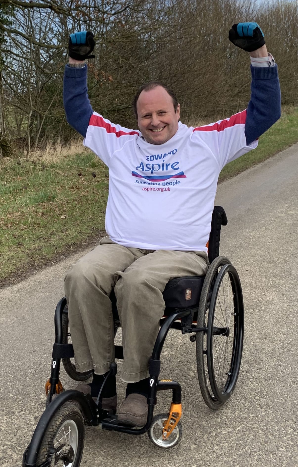 Edward in his Aspire t-shirt in his wheelchair