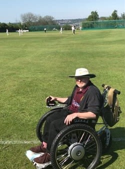 John in his wheelchair watching cricket
