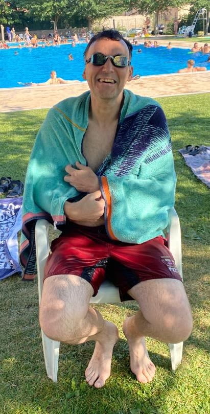 Sebastien wrapped in a towel by an outside pool