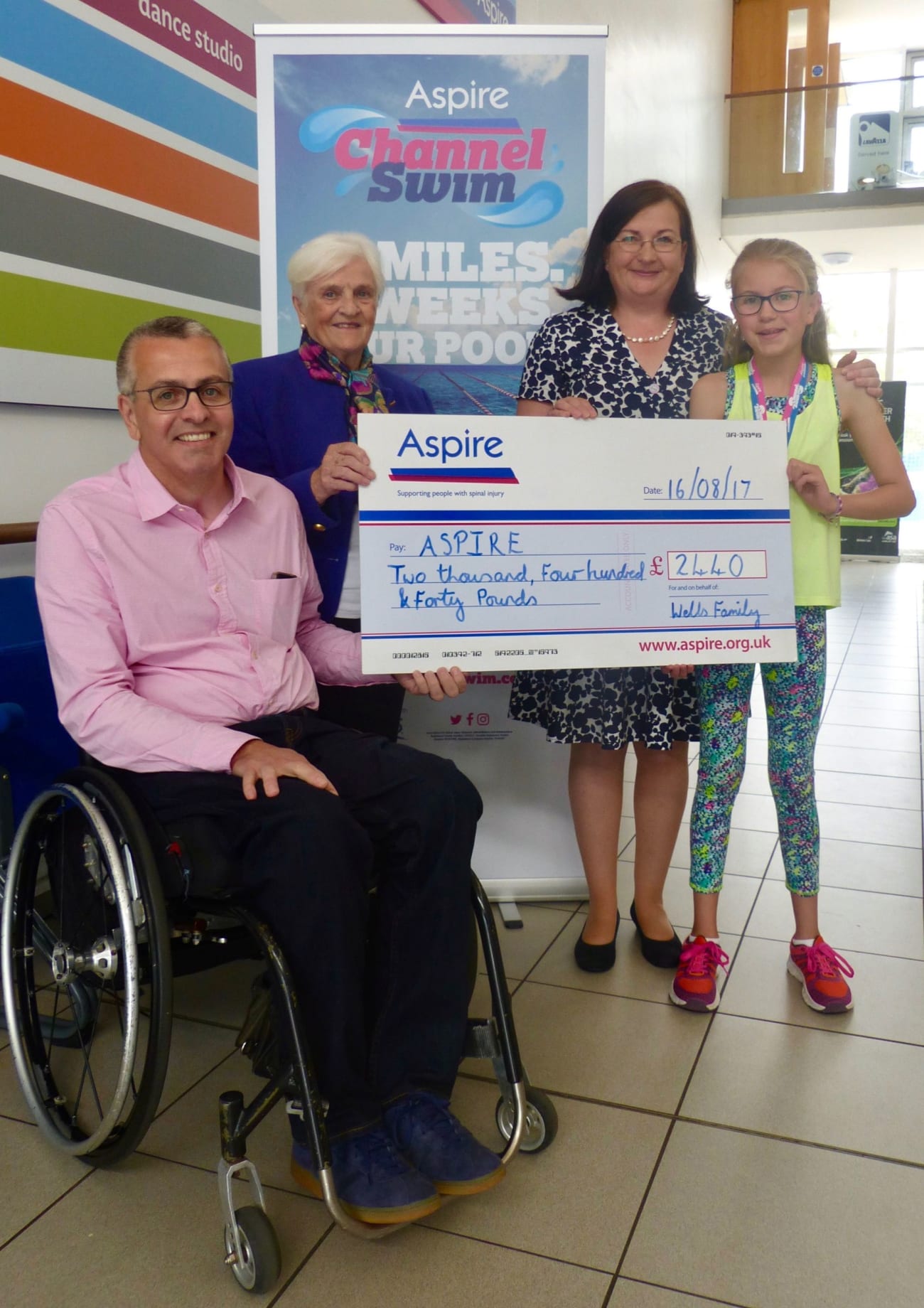 Peter, Valerie, Mary and Lily Wells present large cheque