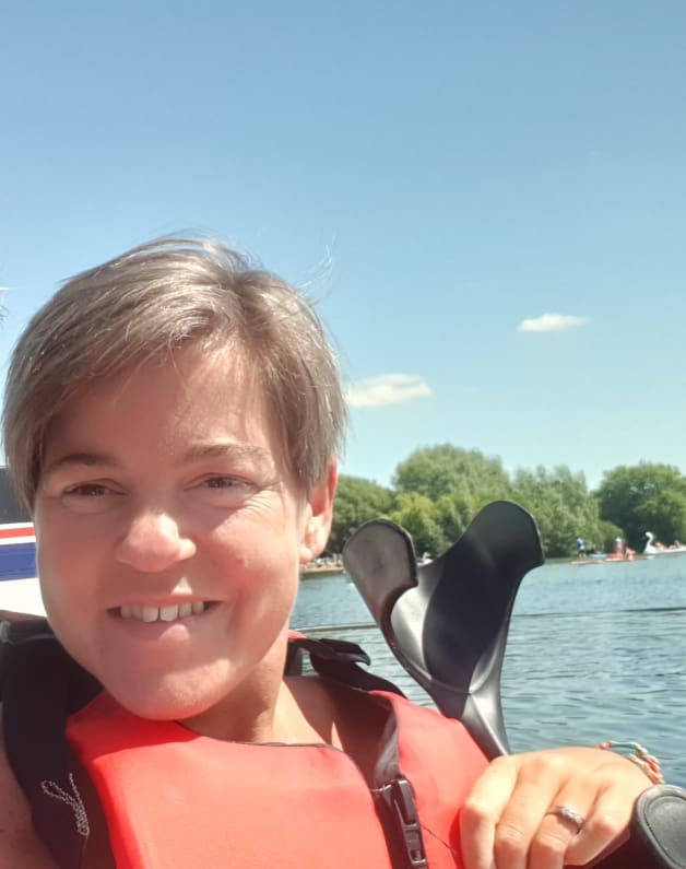 Jo in a life jacket on a lake